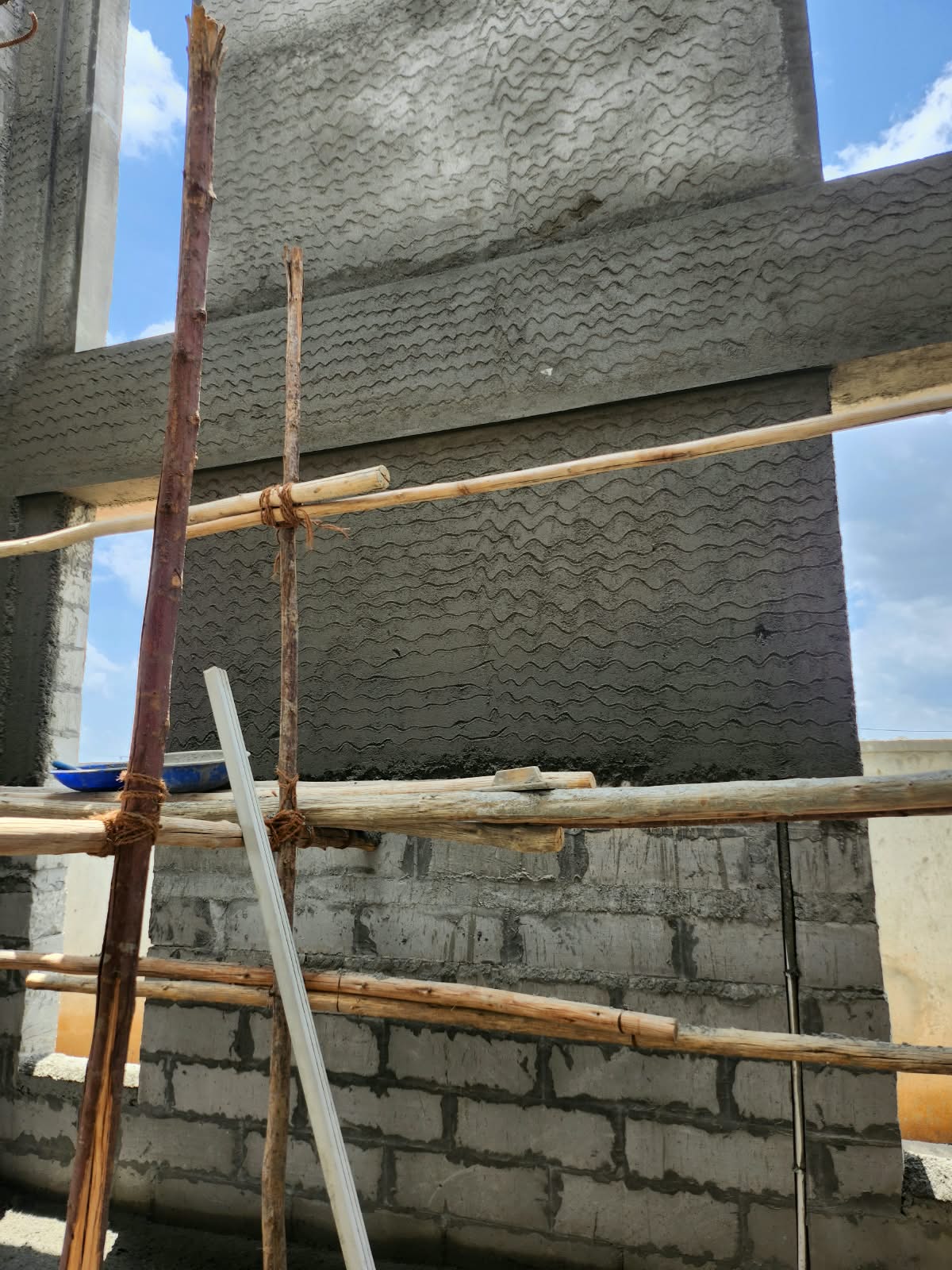External plaster preparation and textured bonding coat at Redsoul Villa